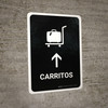 Trolleys With Up Arrow Black Spanish Portrait - Wall Sign