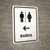 Restrooms With Left Arrow White Spanish Portrait - Wall Sign