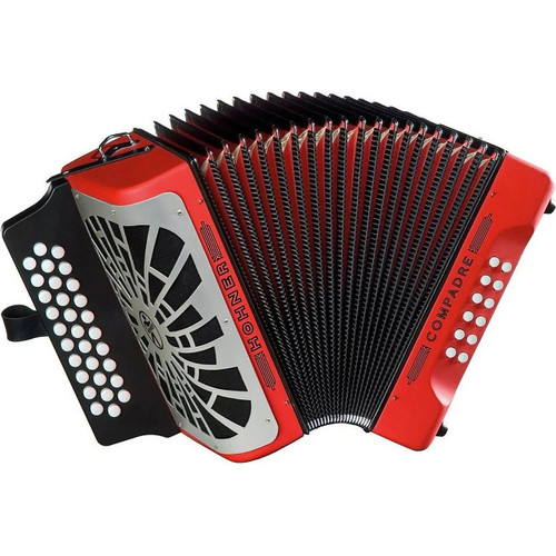 Hohner Compadre diatonic accordion with red and black bellows, white buttons on both sides, and a decorative grille on the left side.