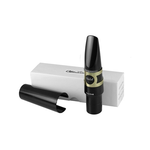 Black baritone saxophone mouthpiece with ligature and cap, displayed in front of a white box with Otto Link branding, arranged on a flat surface.