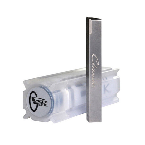 A metallic rectangular object labeled "Classic" stands upright beside a transparent plastic container featuring the "REEDGEEK" logo on one end, both displayed on a flat surface.