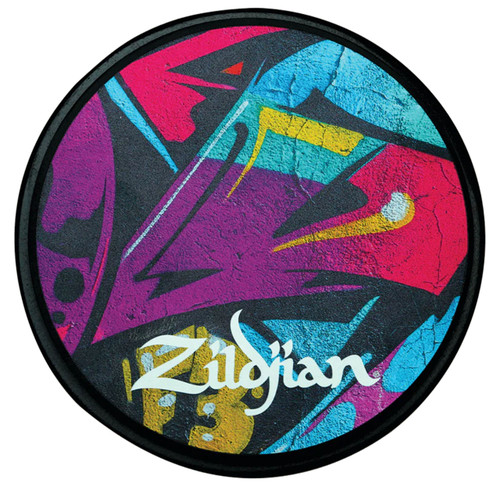 Zildjian Graffiti Practice Pad with a circular shape, featuring a vibrant, abstract graffiti-style design in purple, blue, red, and yellow on a black background.