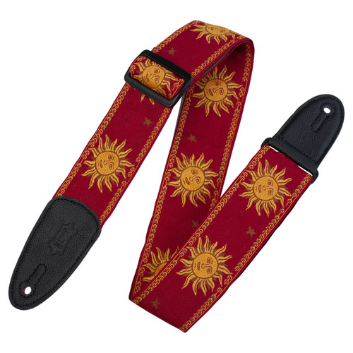 Levy's Sun Motif Series woven guitar strap in red with yellow sun faces, star accents, decorative border, black leather ends, and buckle.