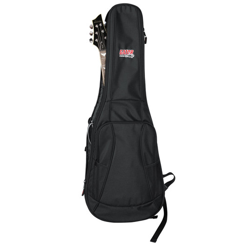 Black Gator Cases gig bag with a guitar partially inside, showing the headstock protruding from the top and multiple zippered storage pockets on the front.
