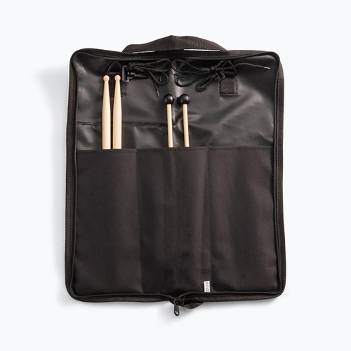 An open black nylon storage bag holding a pair of maple wood drumsticks and a pair of hard black-headed mallets sticking out of the interior organizer slots.