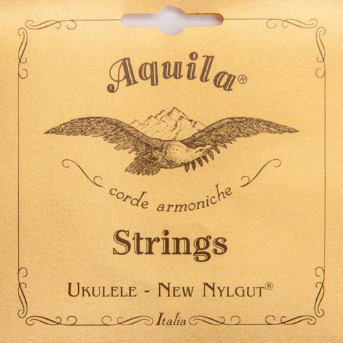 Vintage-style Aquila ukulele strings packaging with a tan background, featuring an illustrated bird with outstretched wings over mountains and decorative border, labeled ‘Aquila Strings Ukulele – New Nylgut Italia.