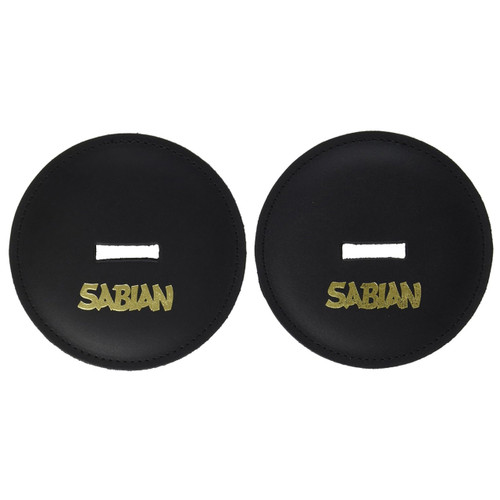A pair of circular black leather hand cymbal pads shown side-by-side on a white background. Each pad features perimeter stitching, a rectangular slot cut into the center for a strap, and a prominent gold-textured "SABIAN" logo printed along the bottom edge.