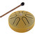 Gold Meinl Pocket Steel Tongue Drum placed next to a wooden mallet with a black rubber tip. The drum has six curved tongue-shaped cutouts and an Om symbol in the center, with the Meinl logo near the edge.