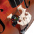 D’Addario Nexxus 360 tuner clipped to a cello bridge, displaying bright full-color LED screen for accurate tuning in orchestral settings. D’Addario Nexxus 360 tuner clipped to a cello bridge, displaying bright full-color LED screen for accurate tuning in orchestral settings.