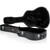 An open black Gator hardshell case designed for a dreadnought guitar, showing its interior lined with foam padding.