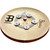A Meinl Byzance cymbal with a central logo and five small metal pieces arranged around it on a wooden surface.