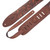 Brown leather guitar strap from Levy's Sundance Series in Geranium Whiskey, featuring intricate floral embossing, multiple adjustment holes, and a stitched design with an additional leather piece for extended adjustment.