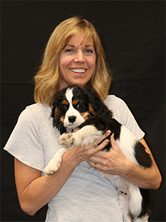 Ted Brown Music President Whitney Grisaffi holding her dog Kona.