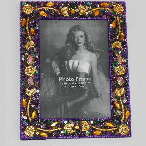 Mardi Gras Pretty in Purple Jeweled Frame. This picture frame is decorated with sequins, acrylic gems, gold leaf and flower details, and purple beads. Measures 7.75in x 5.75in and holds a 4in x 6in photo or a fit to print 5in x 7in photo.
