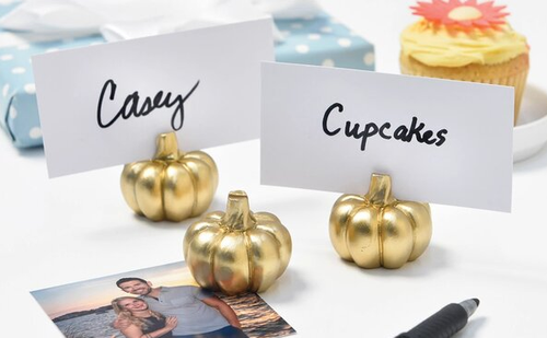 Enhance your fall gatherings with our Pumpkin Placecard Holders! This set features six shiny gold pumpkins, each measuring 1.6 inches, adding a stylish touch to your table decor. Included are six white blank placecards (4 inches by 2 inches) for easy personalization. Perfect for Thanksgiving or any autumn celebration. Enhance your fall gatherings with our Pumpkin Placecard Holders! This set features six shiny gold pumpkins, each measuring 1.6 inches, adding a stylish touch to your table decor. Included are six white blank placecards (4 inches by 2 inches) for easy personalization. Perfect for Thanksgiving or any autumn celebration.