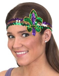 Mardi Gras Fleur de Lis Headband. The headband features a purple and green sequined Fleur de Lis, accented with shimmering gold trim, set on a headband covered in matching purple, green, and gold sequins. One size fits most.