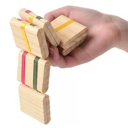 Jacob's Ladder. Made from natural wood and connected with green, yellow, and red ribbons, this timeless toy creates a cascading flipping effect with just a simple tilt. Measures 11.5in.