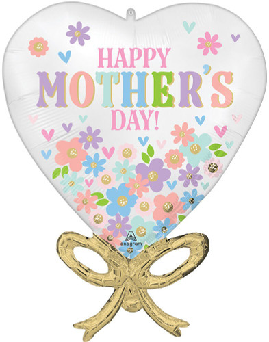 Mother’s Day Daisy Chain Bow Balloon. Designed in a white heart with a gold ribbon shape, it features soft pastel flowers and hearts and the message “HAPPY MOTHER’S DAY!” Balloon is approximately 28 inches after inflation.