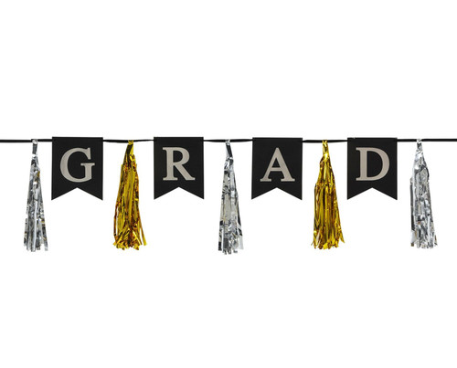 Grad Tassel Streamer. Featuring black flag-shaped cardstock pennants, this banner spells out "GRAD" in silver letters on a black ribbon. Between each letter, shimmering silver and gold foil tassels alternate. Measures 13in x 6ft 6in.