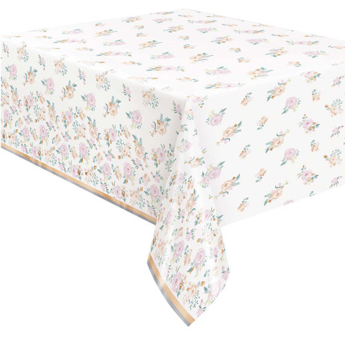 Pink Blooms Foil Tablecover. This rectangular tablecover features a white background decorated with pattern of pink and blush flowers and shimmering rose gold foil accents. Measures 54in x 84in.