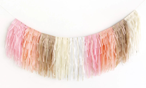 Layered Tissue Fringe Garland with Foil. Designed in a soft palette of light pink, blush, white, ivory, and taupe, this garland is accented with shimmering gold foil strands. Measures 6.9ft.