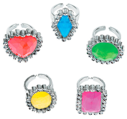 Plastic Rhinestone Rings. Each silver-colored ring features a plastic gem in fun shapes like circles, ovals, rectangles, diamonds, and hearts. The colorful gems come in a mix of pink, red, yellow, green, and blue. Package includes 24 count rings. Amount of each color and shape will vary.