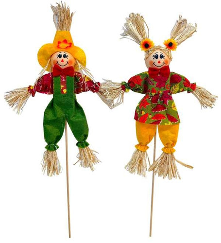 Scarecrow Pick. Made with fabric and straw and available in two designs, one wearing a yellow hat and green overalls and one wearing sunflower pigtails and a leaf pattern dress. Attached to wooden pick. Desired style not guaranteed. Package includes 1 pick measuring 18in. Scarecrow on its own measures about 12in.