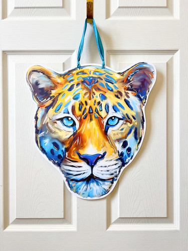Jaguar Door Hanger. Featuring a painterly illustration of jaguar head in blue and gold, this design is printed on a white PVC sign, waterproof and perfect for indoor or outdoor use. A blue ribbon handle adds a festive touch. Measures 14in x 17in without ribbon, .25in thick material.