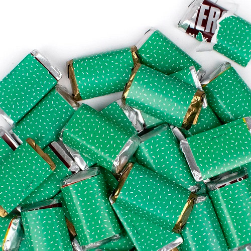 Green Hersheys Miniatures. These bite size miniature chocolate bars wrapped in green with white confetti feature milk chocolate, Krackle, Mr Goodbar, and Special Dark flavors. Net weight 6 ounces.