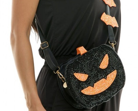 Sequin Jack O Lantern Crossbody Bag. Shaped like a jack o lantern, this bag is covered with black sequins, with orange sequins for the eyes, mouth, and stem. It has an adjustable crossbody strap with additional mini orange sequined bats.
