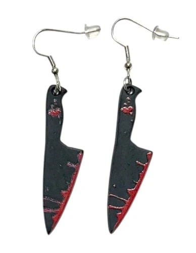 Bloody Weapon Shaped Earrings - Black Carving Knives. Available in multiple styles, including Black Carving Knives, White Serrated Knives, Black Axes, Black Cleavers, Scissors, and White Skinning Knives, these plastic earrings are great accessories for killer costumes. Desired style not guaranteed. Package includes 1 pair of earrings. Sizes range from 1.5in - 2in.