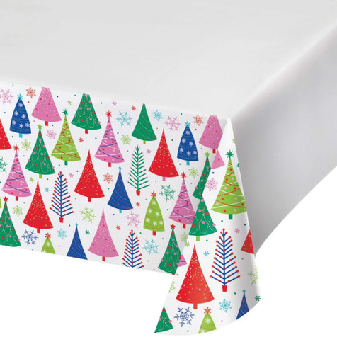 Joyful and Jolly Paper Tablecover. This white rectangular tablecover has a border decorated with a repeating pattern of Christmas trees with different shapes and decorations and snowflakes in green, red, pink, and blue. Measures 54in x 96in.