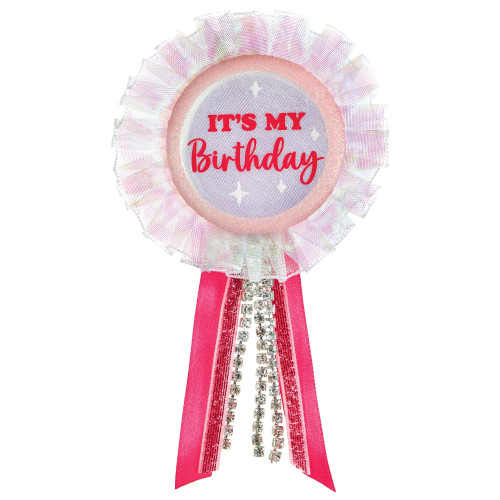 It's My Birthday Pink Award Ribbon. This 2.25in pink iridescent button features "IT'S MY Birthday" in dark pink text and glittery white sparkles, trimmed in iridescent sheer ribbon and with a pink and rhinestone tails. Measures 6.2in with tail.