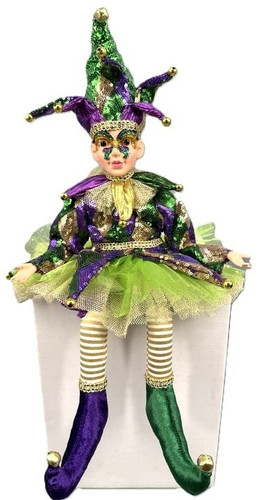 Light Skin Sitting Jester. Dressed in shimmery purple, green, and gold, with a ruffled collar and skirt, bells on his pointed shoes and pointed hat, this jester features somewhat posable arms. His face is adorned with a purple green and gold glitter mask design. Measures about 17in tall with hat.