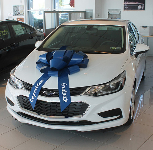 This Blue Car Bow is made of weather resistant PVC with a scratch proof suction cup base. It includes two ribbon tails with "Congratulations" and "Graduate" in white text, measuring 30in x 5in.