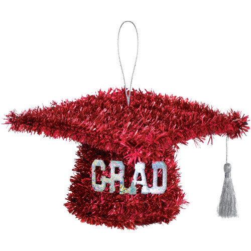 Mini Tinsel Graduation Cap. This small decoration features a red tinsel graduation cap with "Grad” in silver iridescent letters and an attached silver tassel. Measures 3in tall x 5in wide.