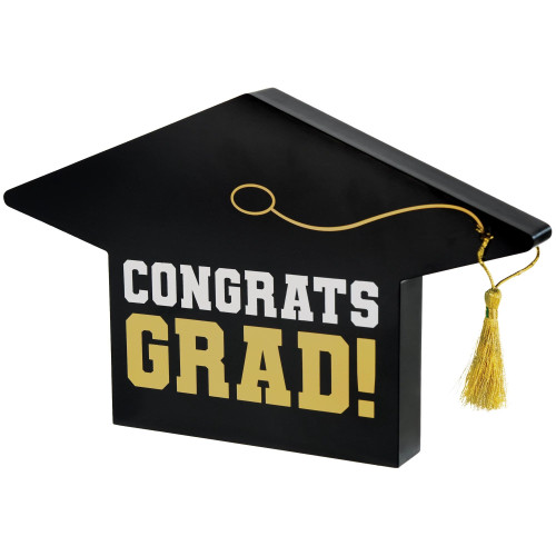 Grad Cap Centerpiece. This black medium density fiberboard centerpiece features a grad cap design with "CONGRATS" in white block letters over "GRAD!" in shimmery gold, with a gold tassel. Measures 6in tall x 10in wide x 1in thick.