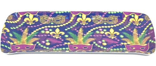 Mardi Gras Mask Melamine Appetizer Tray. Featuring a purpleish blue background, this rectangular tray features a pattern of purple, green, and gold eye masks with feathers, gold filigree masks, gold and purple fleur de lis, and beads. Measures 15in x 6.5in.