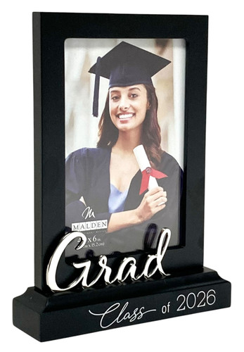 Grad Class of 2026 Standing Frame! This black fiberboard vertical frame features "Grad" in a three dimensional silver tone metal overlay along the top of a black platform base and "Class of 2026" in printed white text along the bottom. Measures 7.5in tall x 5.5in wide with base and holds a 4in x 6in photo.
