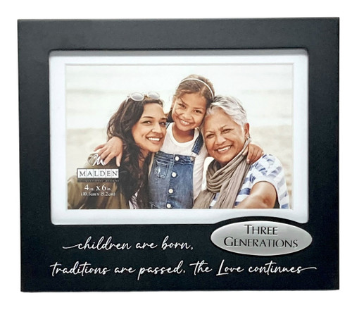 Three Generations Frame. This black fiberboard horizontal frame features "children are born, traditions are passed, the Love continues" in white script along the bottom beside a silver tone three dimensional overlay with "THREE GENERATIONS" in black text. Measures 7.75in x 6.5in and holds a 4in x 6in photo.