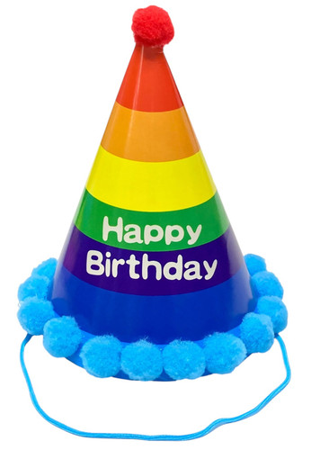 Happy Birthday Primary Rainbow Pom Pom Cone Hat. This printed cardstock cone hat features a horizontal stripes in multiple colors and "Happy Birthday" in a simple white font. On the top is a red pom pom and along the rim are light blue pom poms, and it includes a light blue elastic band. One size fits most. Measures about 7in tall.