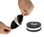 Squishy Rubber Pull Apart Cookie. With the appearance of a sandwich cookie with colorful sprinkles, this squishy rubber toy has layers that can be pulled apart and put back together. Package includes 1 count toy measuring about 2.25in.