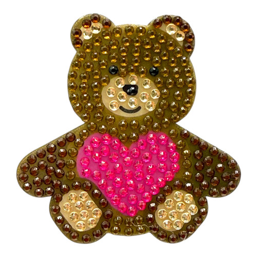Stickerbeans Rhinestone Sticker - Teddy Bear. This sparkly sticker features a brown and cream teddy bear with a pink heart. Package includes 1 count sticker measuring about 1.75in x 2in.