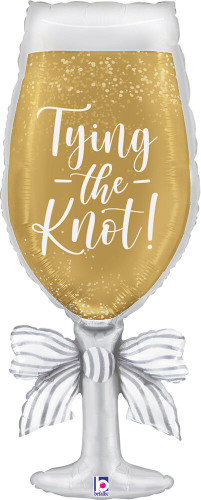 Satin Tying the Knot Champagne Balloon. This large, shaped balloon is of a champagne glass with a silver wrapped stem and the text "Tying the Knot!" in white script. Balloon is approximately 34 inches after inflation.