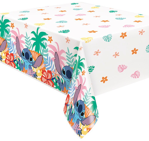 Stitch Plastic Tablecover. This white rectangular plastic tablecover features a pattern of colorful flowers and leaves. Along the edge is a repeating pattern of more colorful leaves, flowers, and palm trees as well as Stitch raising his paws. Measures 54in x 84in.