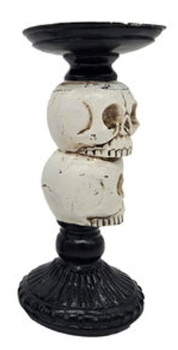 Halloween Pillar Candle Holder - Skulls. This black candle holder, available with either a black crow or white skulls, features a fancy design straight out of a haunted manor. Made to hold a standard pillar candle. Desired style not guaranteed. Package includes 1 count candle holder measuring 7.25in tall x 3in diameter.