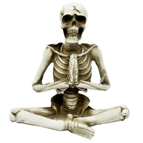 Easy Pose Sculpture Decoration. This resin sculpture features a white skeleton in a meditative yoga easy pose, perfect for a shelf, table, or mantel. Measures 4.5in wide x 5.25in tall.