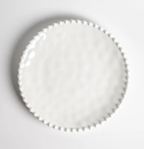 Beaded Pearl Melamine Luncheon Plate. This sturdy, reusable hard plastic plate features a creamy white color with a raised beaded border. Package includes 1 count plate measuring 9in.