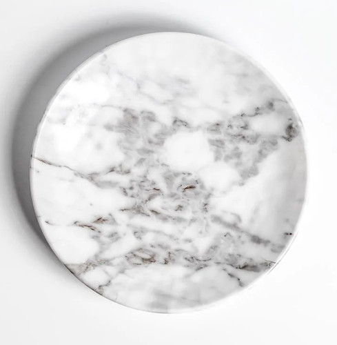 Melamine Marble Luncheon Plate. This sturdy, reusable, slightly organically round, hard plastic plate features a white marble finish. Package includes 1 count plate measuring about 8.5in.