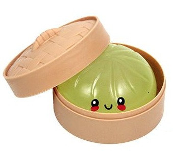 Glow in the Dark Squeezy Dumpling. Shaped like a round dumpling with a cute face, this stress toy arrives in a mystery color and can glow in the dark when exposed to light. Desired color not guaranteed, no returns or exchanges. Package includes 1 count toy measuring about 3.5in in a plastic steamer pot shaped container measuring 3.75in in diameter, 1.8in tall.